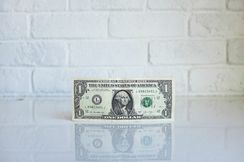 a single dollar on a counter top