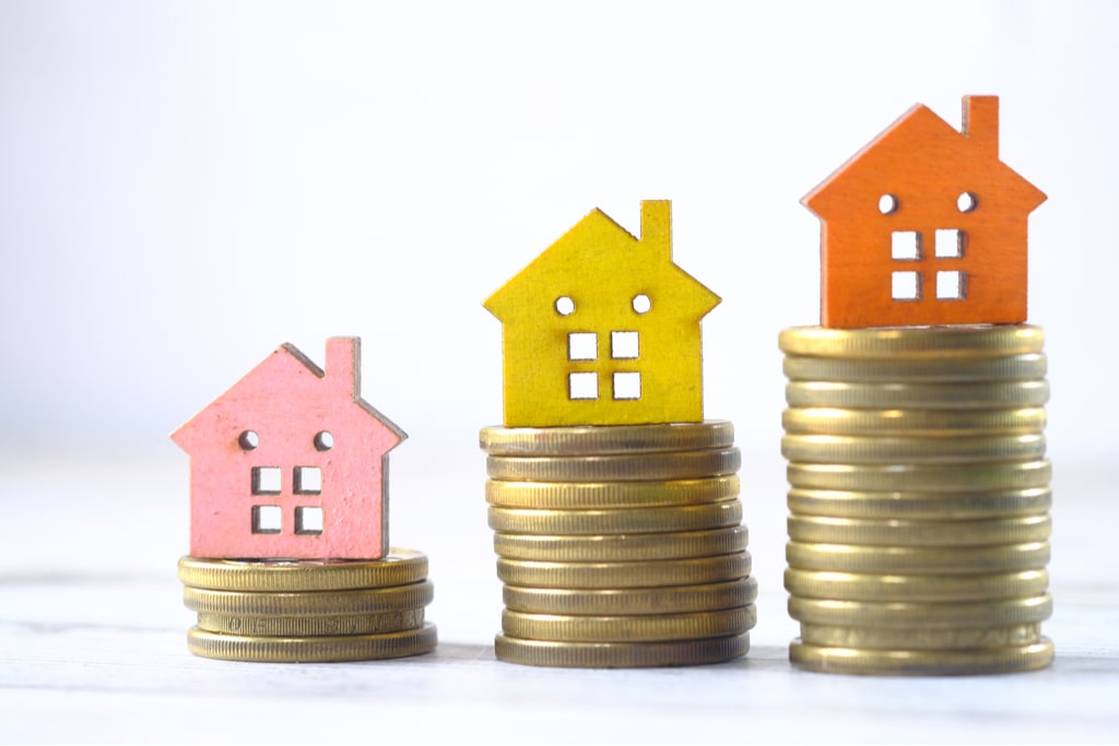 stack of coins with house fixtures on the top