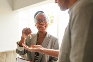 landlord handing over the keys to their new tenant