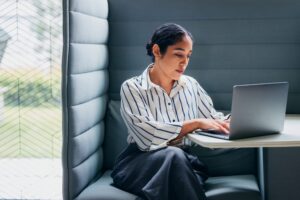 woman landlord using property management software on her laptop