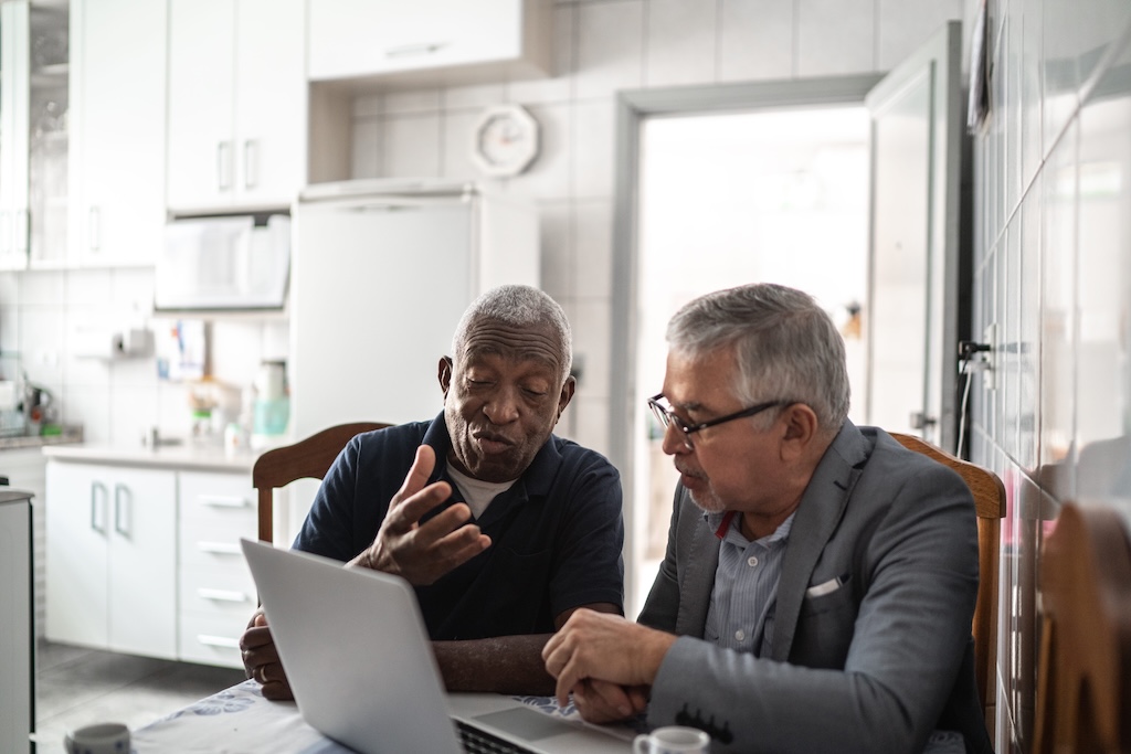 two landlords reviewing an online lease agreement on their laptop