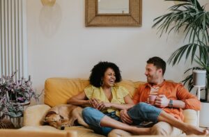 two renters on the couch with their pet