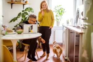 two renters in their kitchen with their pet dog